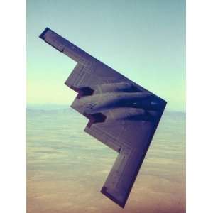 Stealth Bomber Flying over Desert Like Landscape Photographic 