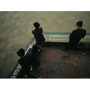 Men Stand Against the Railing of a Boat on the Yangtze River Stretched 